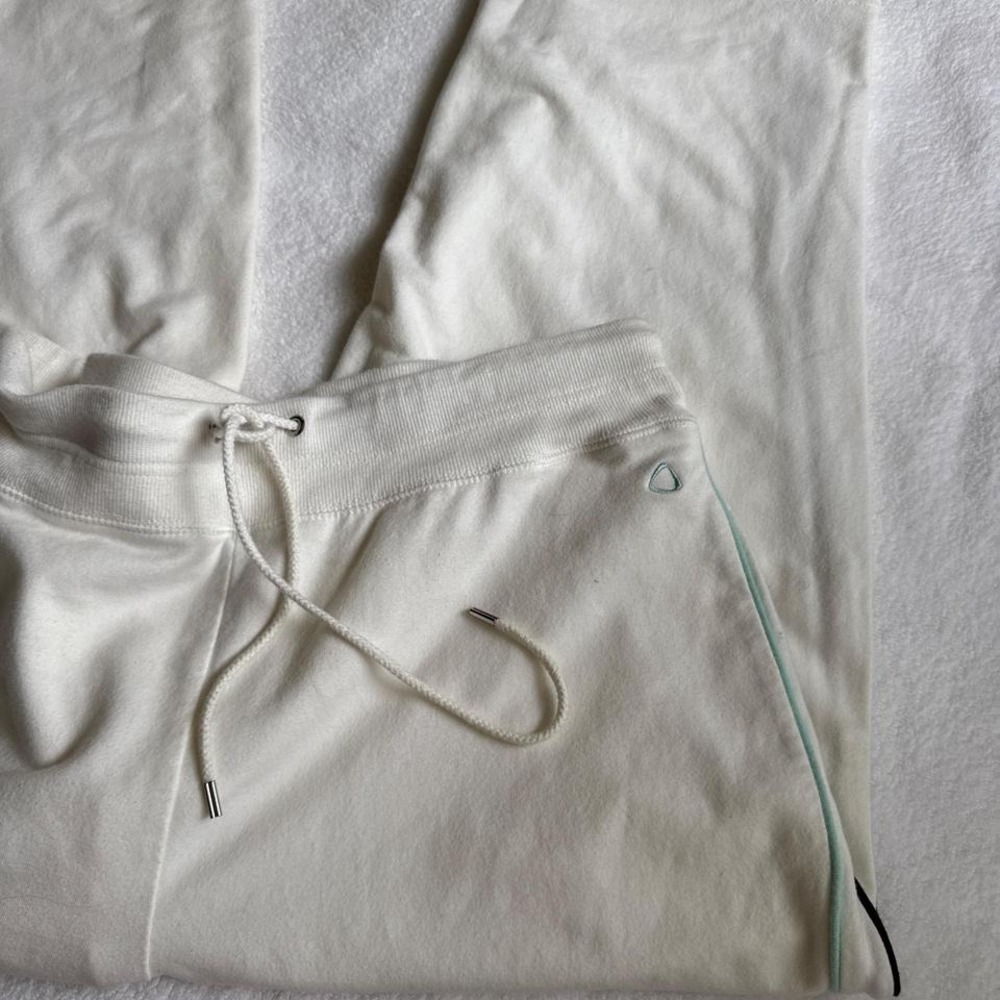 white sweatpant capris with blue and black stripe down the sides